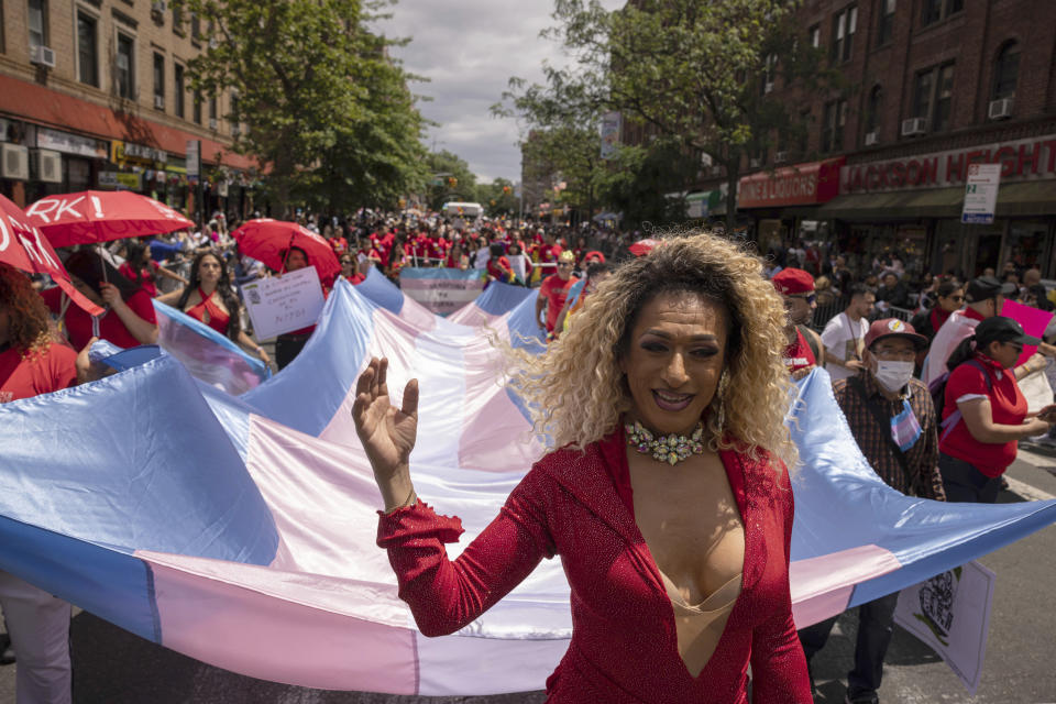 FILE - Participants hold a large transgender flag during the 31st annual Queens Pride Parade and Multicultural Festival, Sunday, June. 4, 2023, in New York. Transgender and nonbinary people are front and center this year at Pride festivals where they've often been sidelined. (AP Photo/Yuki Iwamura, File)