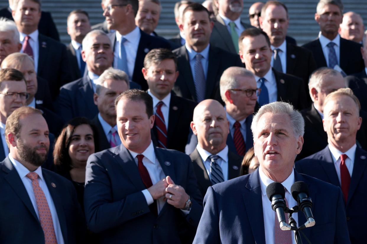 House Minority Leader Kevin McCarthy (lower right) speaks in front of the House steps while surrounded by GOP caucus members on November 17, 2021 in Washington, DC.