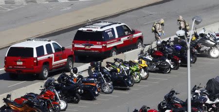 Emergency workers in hazmat suits work in a Pentagon parking lot after a woman who recently traveled to Africa vomited there, in Washington October 17, 2014. REUTERS/Kevin Lamarque