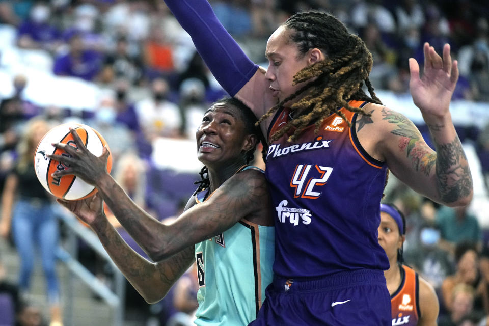 New York Liberty forward Natasha Howard drives on Phoenix Mercury center Brittney Griner (42) during the second half in the first round of the WNBA basketball playoffs, Thursday, Sept. 23, 2021, in Phoenix. Phoenix won 83-82. (AP Photo/Rick Scuteri)