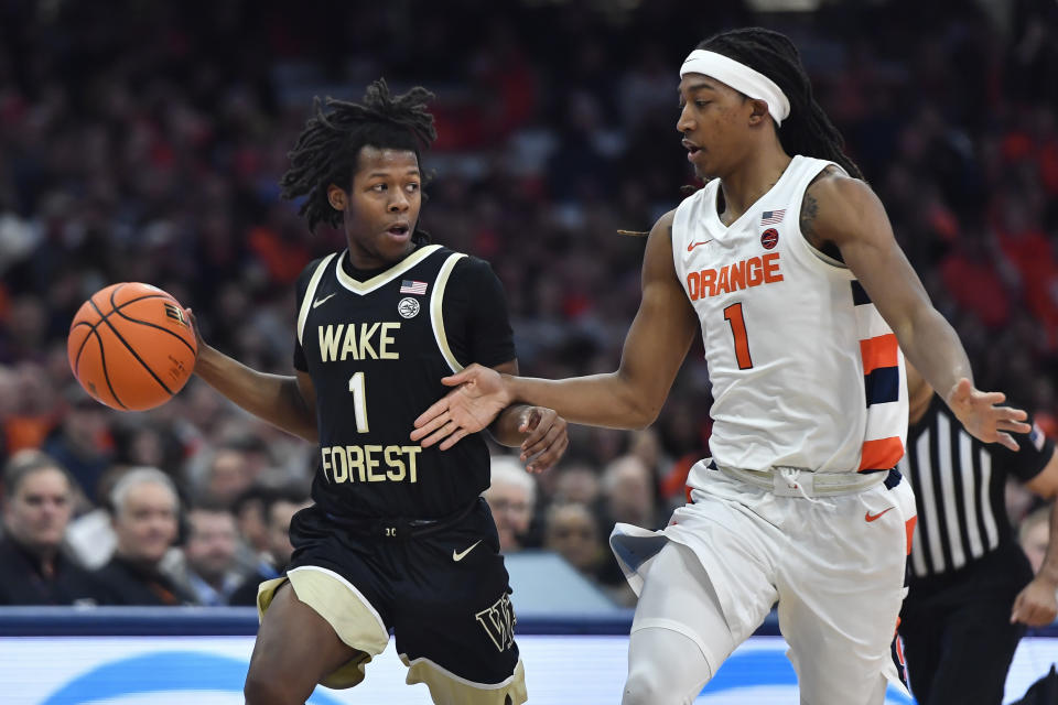 Wake Forest guard Tyree Appleby, left, is defended by Syracuse forward Maliq Brown, right, during the first half of an NCAA college basketball game in Syracuse, N.Y., Saturday, March 4, 2023. (AP Photo/Adrian Kraus)