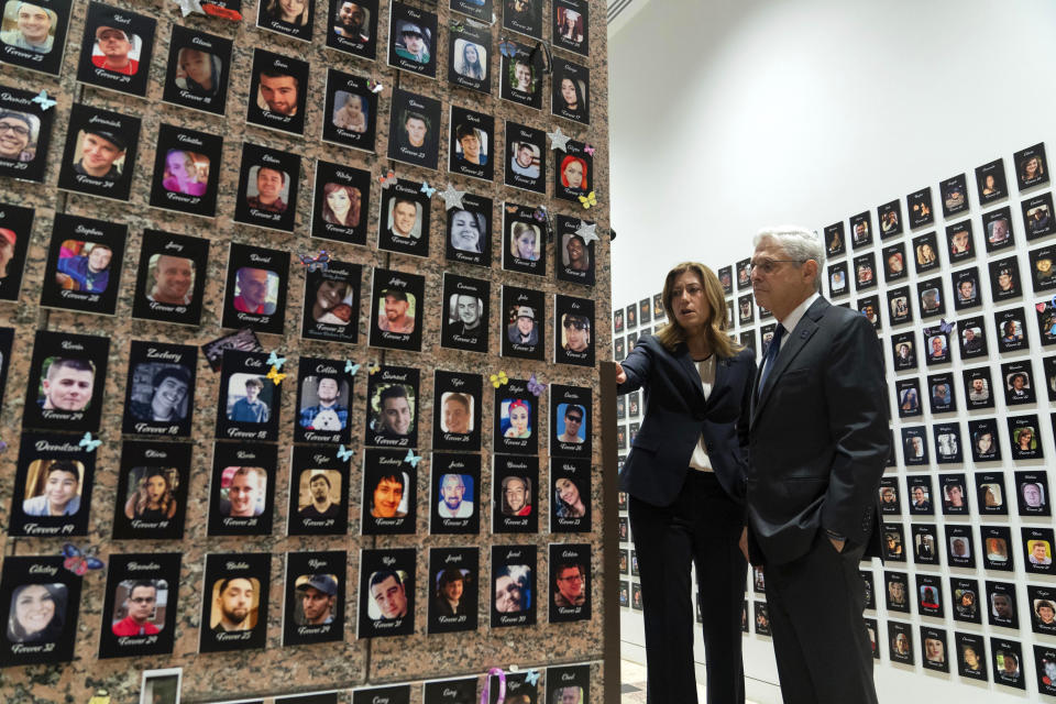 Attorney General Merrick Garland accompanied by U.S. Drug Enforcement Administration Administrator Anne Milgram, looks at photographs of people who had died from drugs during the Second Annual Family Summit on Fentanyl at DEA Headquarters in Washington, Tuesday, Sept. 26, 2023. (AP Photo/Jose Luis Magana)