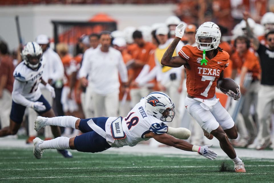 Texas wide receiver Isaiah Bond runs the ball around UTSA safety Jimmy Wyrick after a catch during the first quarter of the Longhorns' game against the UTSA Roadrunners Saturday at Royal-Memorial Stadium.