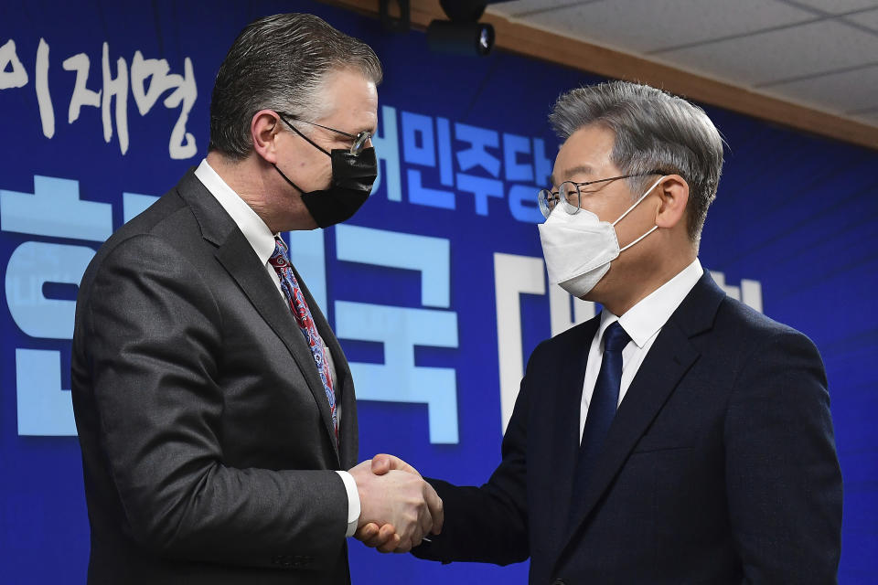 U.S. assistant Secretary of State for East Asian and Pacific Affairs Daniel J. Kritenbrink, left, shakes hands with South Korean Presidential candidate Lee Jae-myung at the ruling Democratic Party headquarters in Seoul, South Korea, Thursday, Nov. 11, 2021. Kritenbrink arrived in South Korea on Wednesday on the second leg of his two-stop Asia trip and will meet with senior government officials. (Kim Min-hee/Pool Photo via AP)