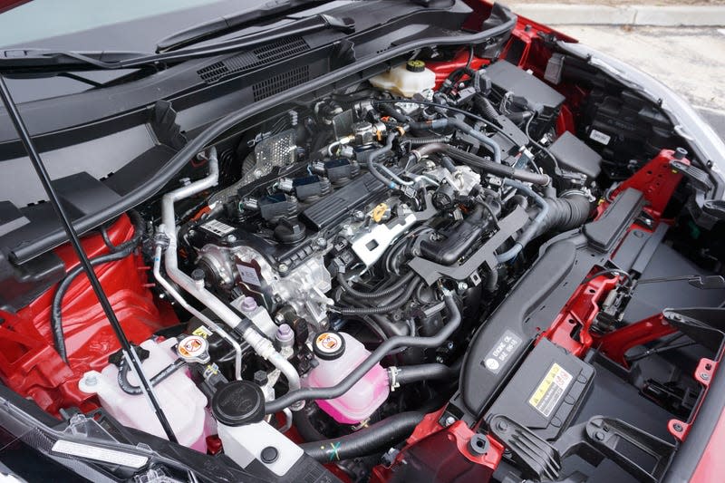 A red 2023 Toyota Corolla Cross Hybrid.