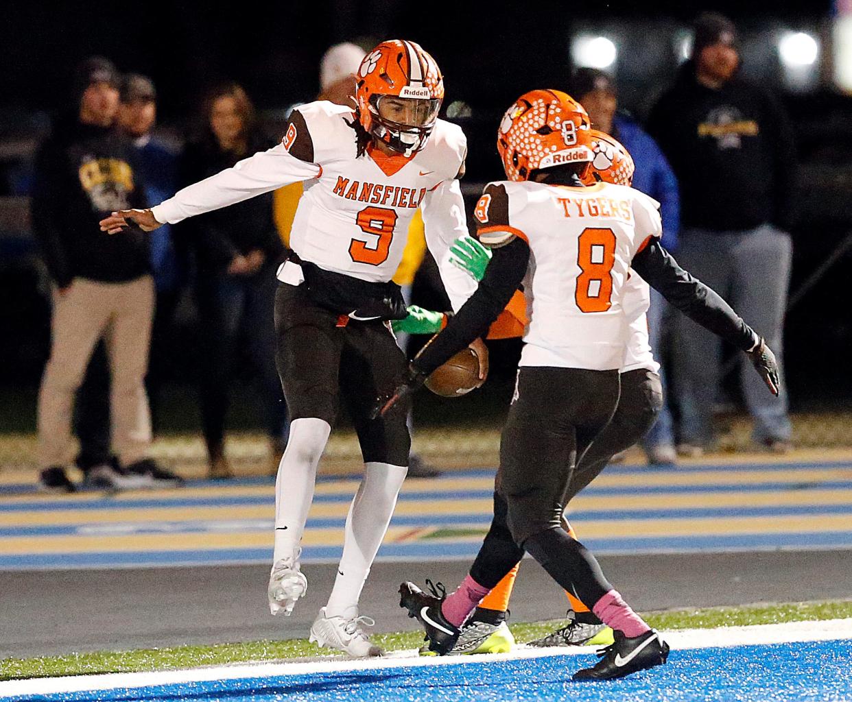 Mansfield Senior High School's Duke Reese (9) celebrates with Amarr Davis (8) after his first quarter touchdown against Toledo Central Catholic High School during their OHSAA Division III Region 10 high school football semifinal game action Friday, Nov. 10, 2023 at Bob Bishop Stadium in Clyde. TOM E. PUSKAR/MANSFIELD NEWS JOURNAL
