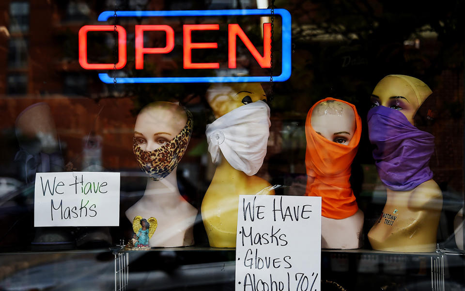 Mannequin heads wear masks in the window of a small boutique advertising availability of mask in Arlington, Virginia. Source: Getty Images