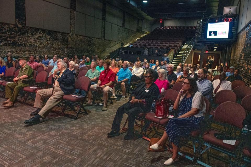 The crowd listens Sunday as economist John List speaks during a CivicCon presentation at the  REX Theatre in Pensacola.