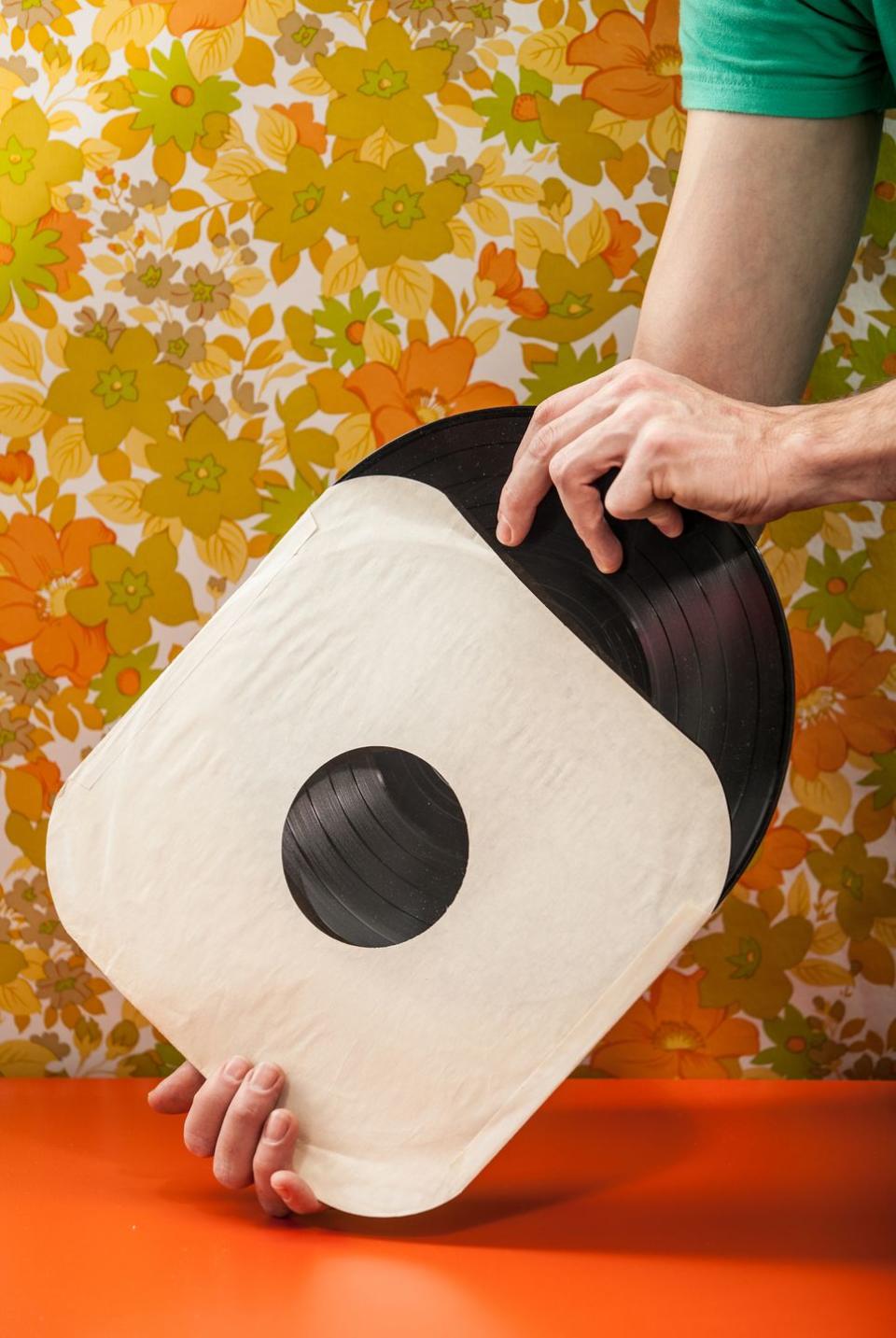 vintage vinyl record being removed from paper cover