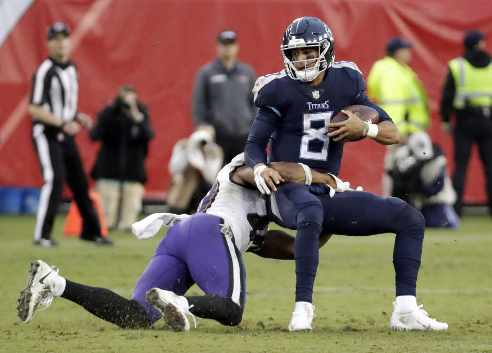 Tennessee Titans quarterback Marcus Mariota (8) is sacked for a 3-yard loss by Baltimore Ravens linebacker Kenny Young (40) in the second half of an NFL football game Sunday, Oct. 14, 2018, in Nashville, Tenn. (AP Photo/James Kenney)