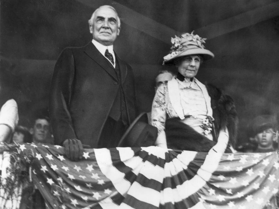 Then-President Warren Harding and his wife Florence Harding watch a horse show from a balcony in 1921.