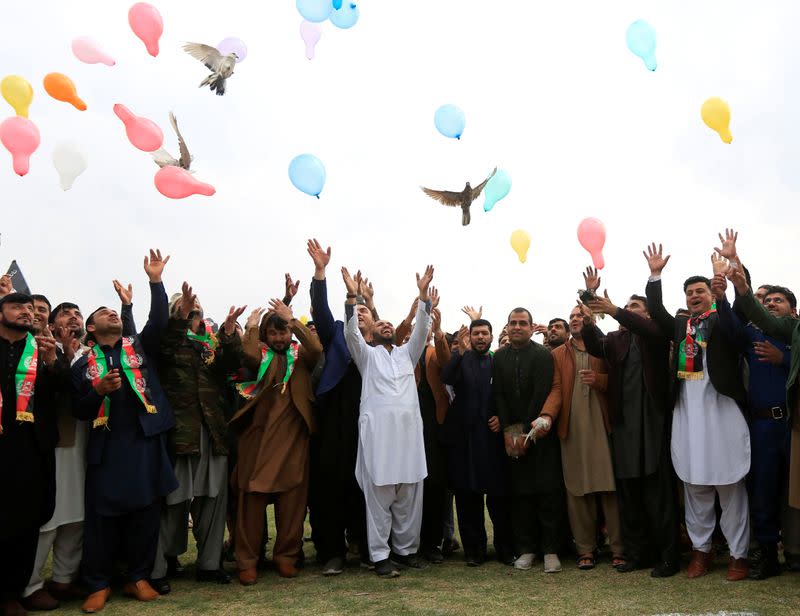 Afghan men celebrate in anticipation of the U.S-Taliban agreement to allow a U.S. troop reduction and a permanent ceasefire, in Jalalabad