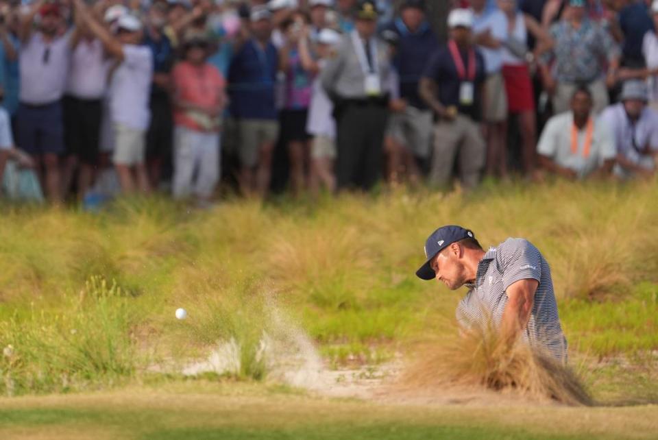 Bryson DeChambeau hits onto the eighteenth green during the final round of the U.S. Open golf tournament.