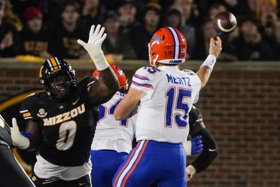 Missouri Tigers defensive lineman Jayden Jernigan (No. 0) gets a hand in the face of Florida Gators (and former Blue Valley North) quarterback Graham Mertz during Saturday night’s game at Faurot Field at Memorial Stadium in Columbia, Mo.