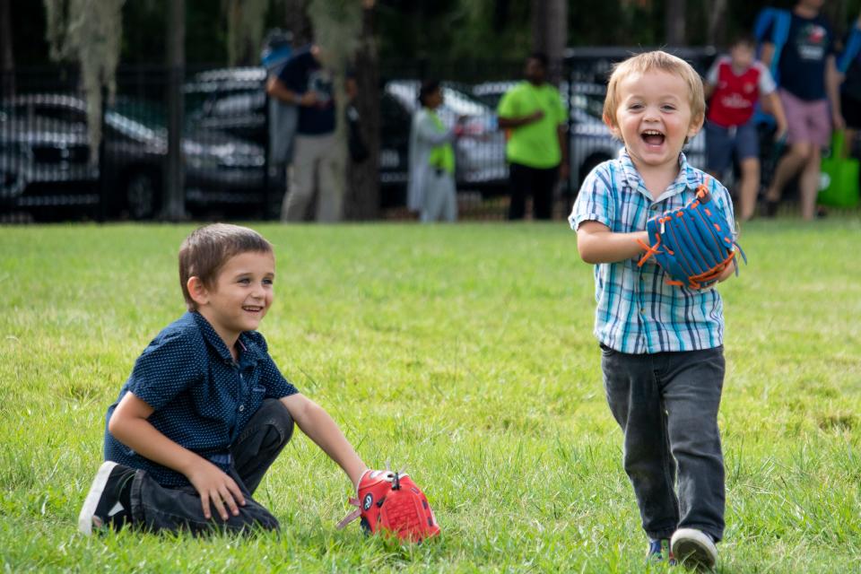 Oliver Yelvington, 5, left, plays baseball with brother August, 2, during WUFT’s Fanfares and Fireworks at Flavet Field in Gainesville on July 3, before the fireworks show later in the evening.