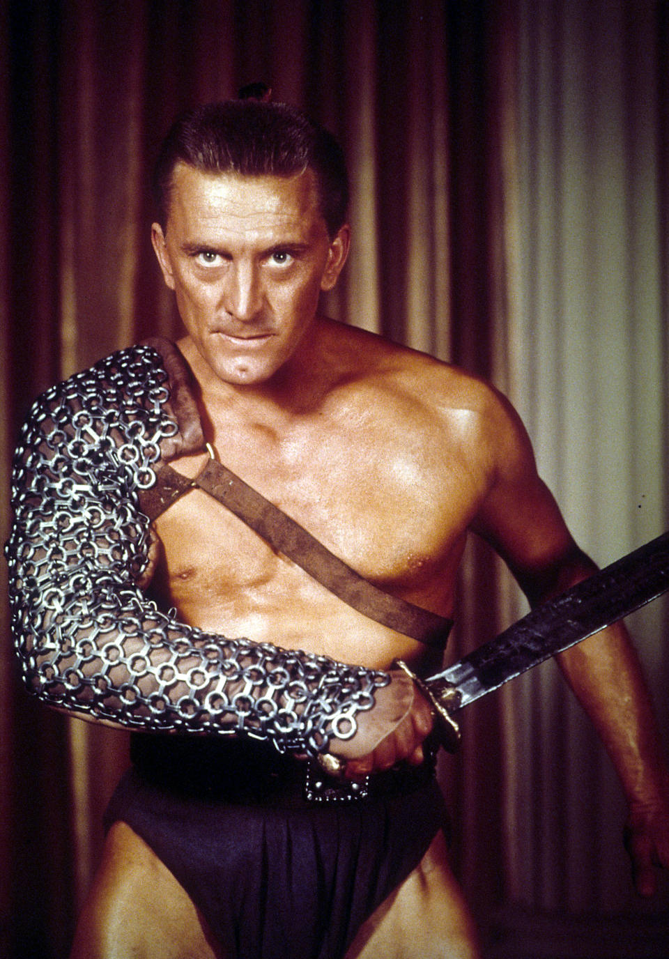 Kirk Douglas the slave Spartacus, ready to fight in a scene from the film 'Spartacus', 1960. (Photo by Universal Pictures/Getty Images)