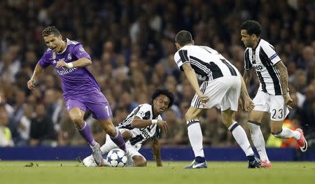 Britain Soccer Football - Juventus v Real Madrid - UEFA Champions League Final - The National Stadium of Wales, Cardiff - June 3, 2017 Real Madrid's Cristiano Ronaldo is fouled by Juventus' Juan Cuadrado Reuters / Carl Recine Livepic