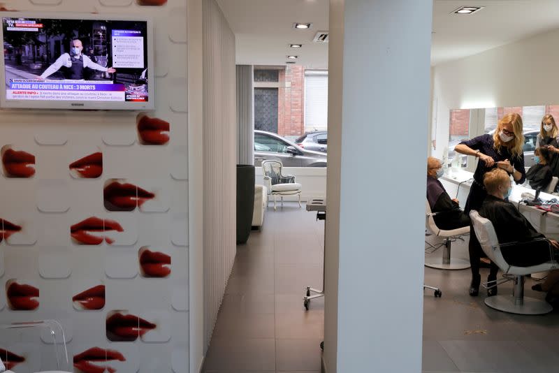 A screen tv is seen in a hairdresser shop in Cambrai a few hours before introducing a new lockdown