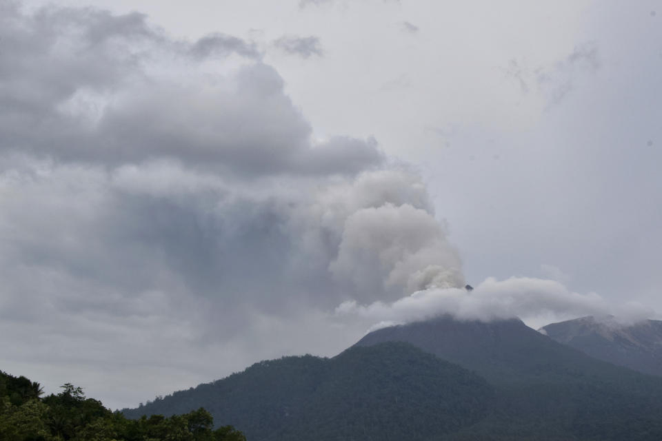 Mount Lewotobi Laki-Laki spews volcanic materials from its crater during an eruption in East Flores, Indonesia, Sunday, Jan. 14, 2024. Thousands of residents in nearby villages have been evacuated from their homes following the increased activity of the more than 2,200-meter (7,200 ft) volcano. (AP Photo/Andre Kriting)