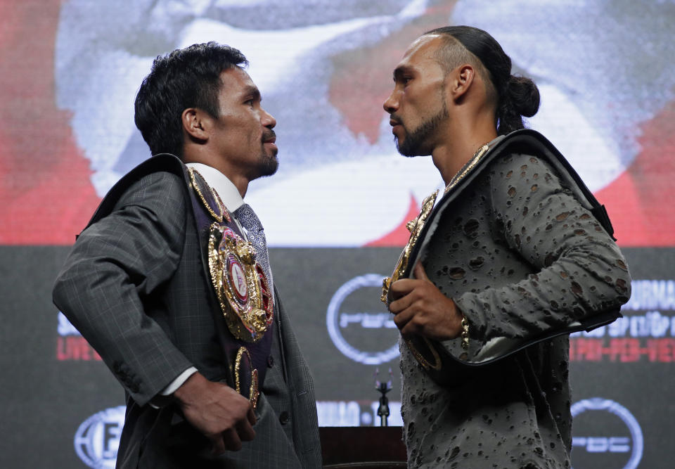 Manny Pacquiao, left, and Keith Thurman pose during a news conference Wednesday, July 17, 2019, in Las Vegas, for their welterweight championship boxing match scheduled for Saturday in Las Vegas. (AP Photo/John Locher)