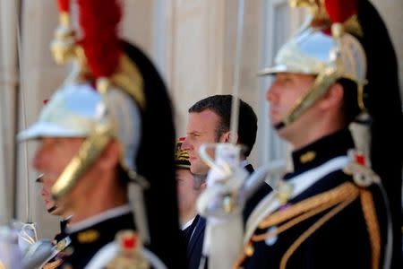 French President Emmanuel Macron waits for guests to leave at the Elysee Palace in Paris, France, June 26, 2017. REUTERS/Philippe Wojazer