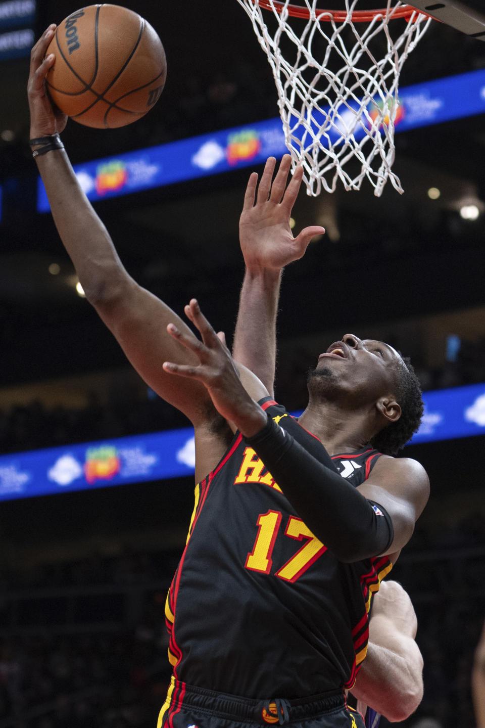 Atlanta Hawks forward Onyeka Okongwu (17) scores against the Sacramento Kings during the first half of an NBA basketball game Friday, Dec 29, 2023, in Atlanta. (AP Photo/Hakim Wright Sr.)