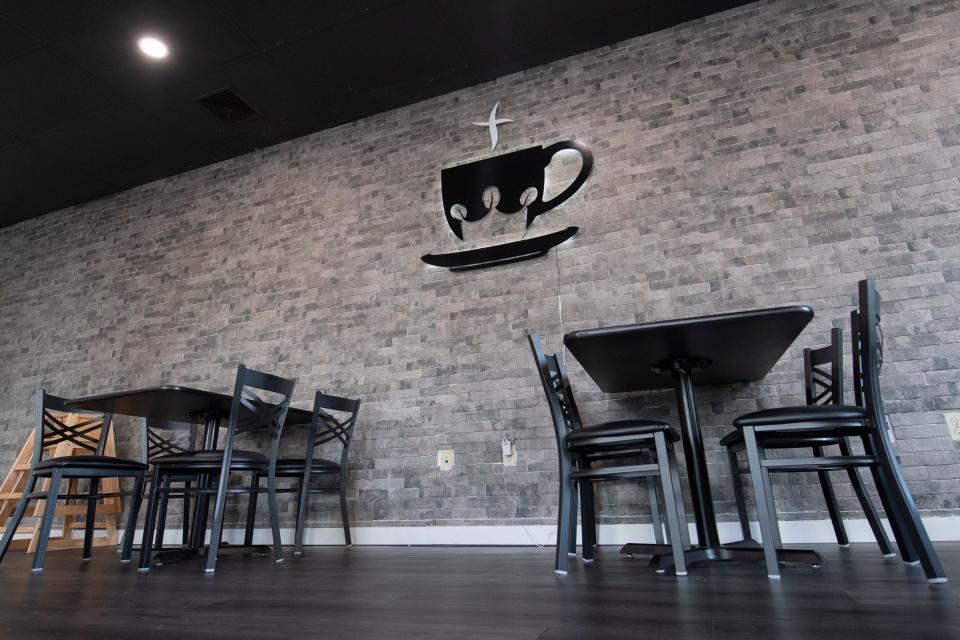 Kingdom City Coffeehouse features a faith-based logo with a king crown on the wall at its downtown Salem space.