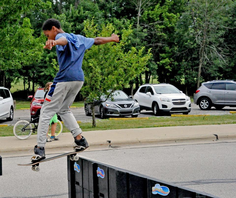 Jayshaun Foster tries the big jump on his skate board Saturday at a fundraiser for an Orrville skate park.
