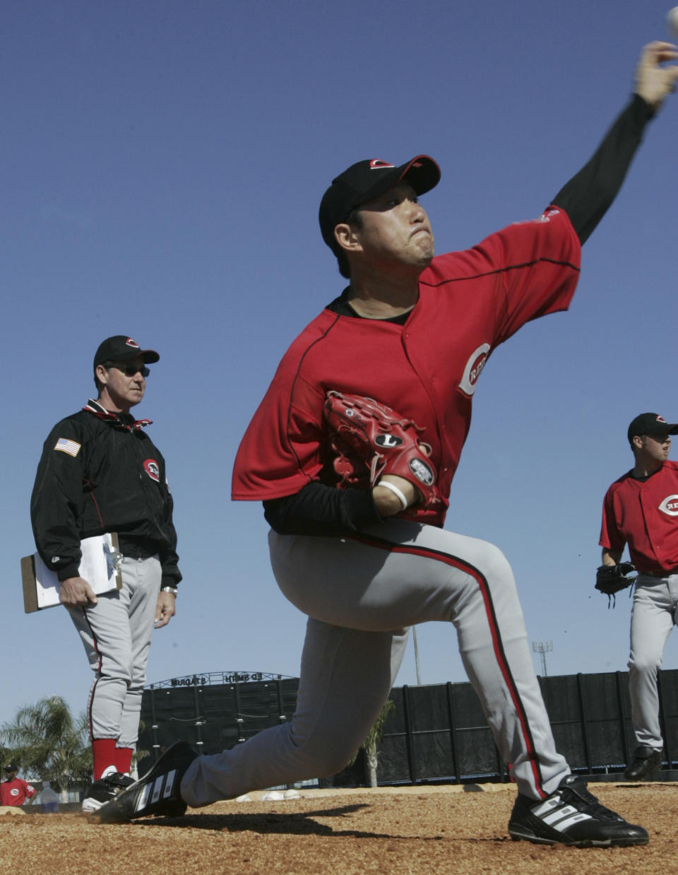 FILE - Cincinnati Reds pitcher Jung Keun Bong throws as pitching coach Don Gullett, left, watches during baseball spring training Feb. 19, 2005, in Sarasota, Fla. Gullett, a former major league pitcher and coach who played for four consecutive World Series champions in the 1970s, died Wednesday, Feb. 14, 2024. He was 73. The Reds, New York Yankees and Baseball Hall of Fame all paid tribute to Gullett in social media posts. There was no information provided on his death, but the Cincinnati Enquirer reported he had recent health issues. (AP Photo/Al Behrman, File)