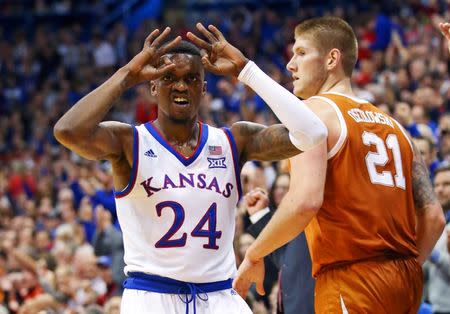 Jan 14, 2019; Lawrence, KS, USA; Kansas Jayhawks guard Lagerald Vick (24) celebrates after scoring as Texas Longhorns forward Dylan Osetkowski (21) looks on in the second half at Allen Fieldhouse. Mandatory Credit: Jay Biggerstaff-USA TODAY Sports