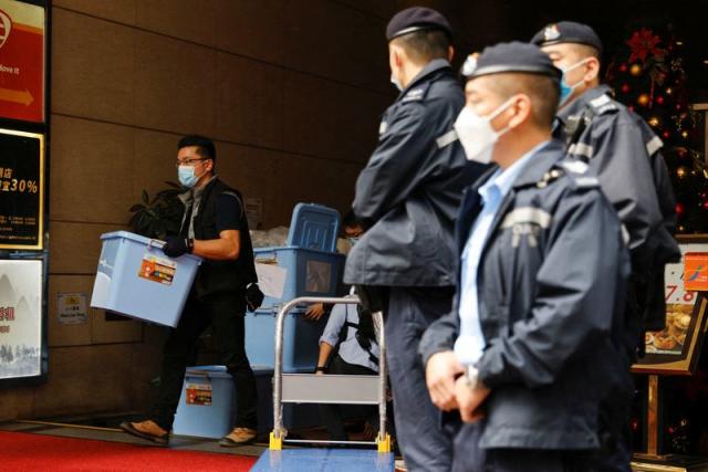 A police collects a box of evidence after a police search at the office of Stand News, in Hong Kong