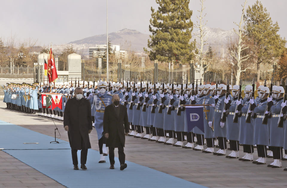 Turkish President Recep Tayyip Erdogan, left, and Germany's Chancellor Olaf Scholz review a military honour guard during a ceremony in Ankara, Turkey, Monday, March 14, 2022. Scholz is visiting Turkey Monday in his first official trip to the country since he took office in December. He will hold talks with Turkish President Recep Tayyip Erdogan in Ankara.(AP Photo/Burhan Ozbilici)