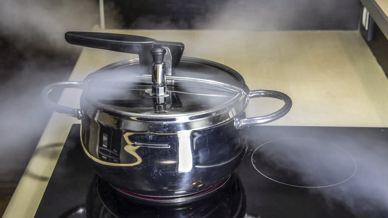 Pressure cooker releasing steam