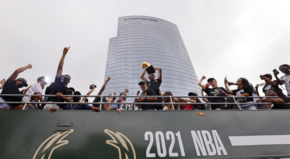 Milwaukee Bucks' Giannis Antetokounmpo, third from left, gestures during a parade for the basketball team's NBA Championship win, Thursday, July 22, 2021, in Milwaukee. (AP Photo/Jeffrey Phelps)