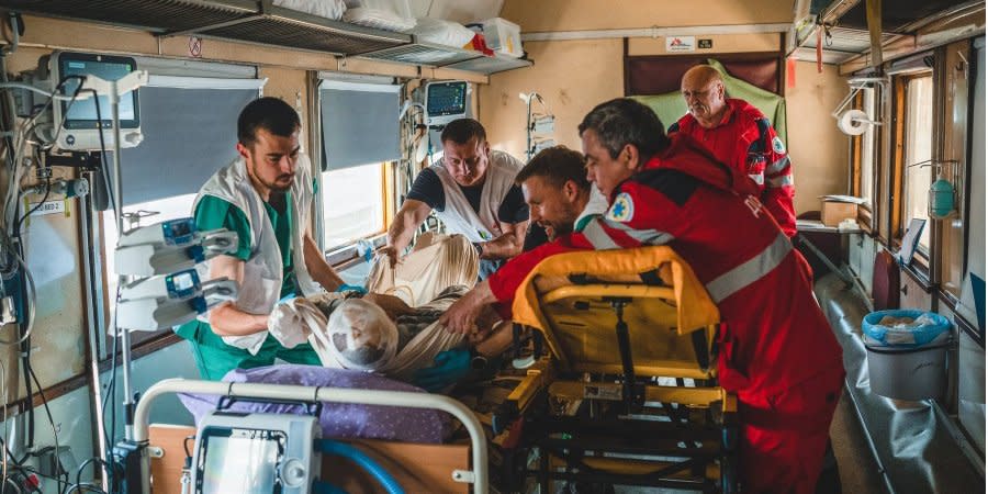 Doctors stabilize one of the wounded civilians in Donbas in a medical train to take him to a safer place