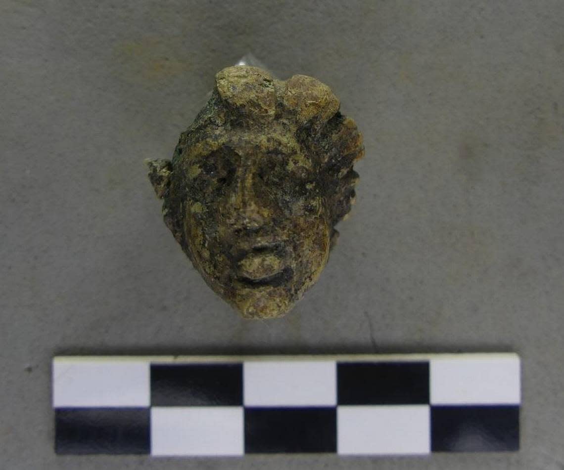 A bronze head found at the site.