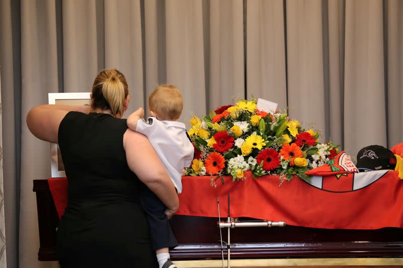 Mourners stand near the coffin of late RFS volunteer Keaton during his funeral in Buxton