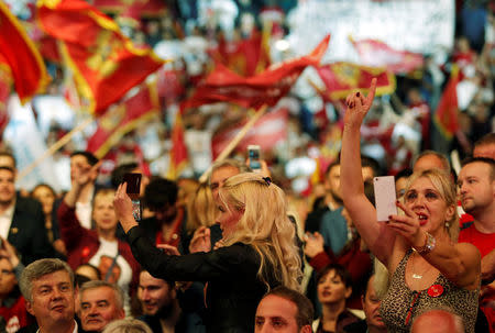 A supporter of rulling Democratic Party of Socialist takes a selfie during a pre-election rally in Podgorica, Montenegro, October 14, 2016. REUTERS/Stevo Vasiljevic