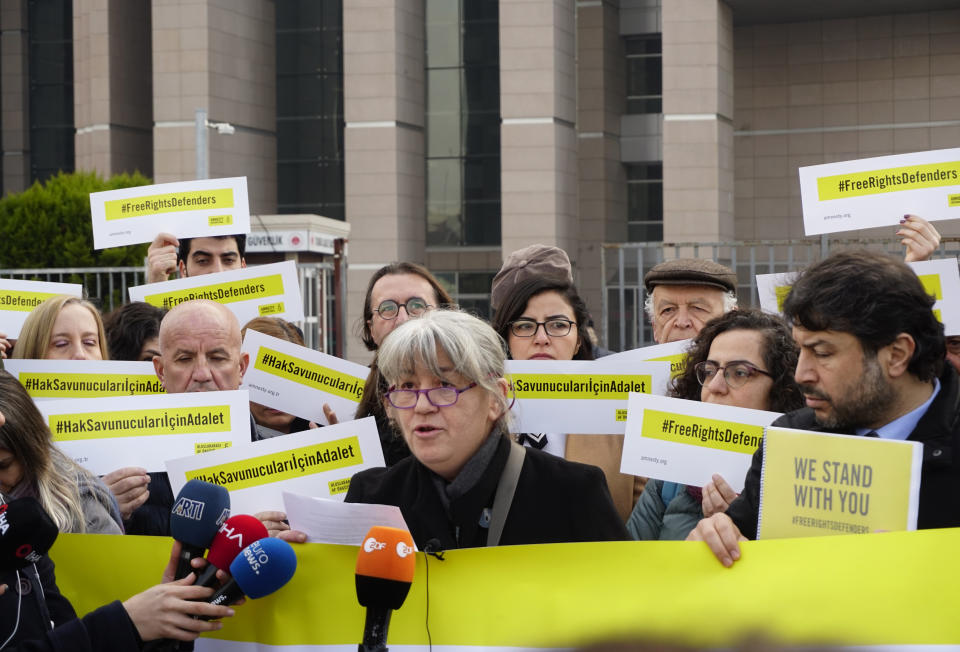 Turkish activist Feray Salman and international human rights activists speak to the media before the trial of the Amnesty International's former Turkey chairman and 10 other activists, in Istanbul, Wednesday, Feb. 19. 2020. A court in Istanbul will hand down verdicts for defendants in the closely-watched trial on charges of belonging to or aiding terror groups. The case against activists heightened concerns about Turkey's treatment of human rights defenders. (AP Photo)