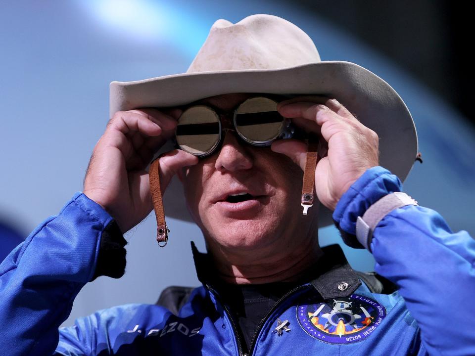 Blue Origin founder Jeff Bezos wears a pair of reflective aviation glasses under a cowboy hat