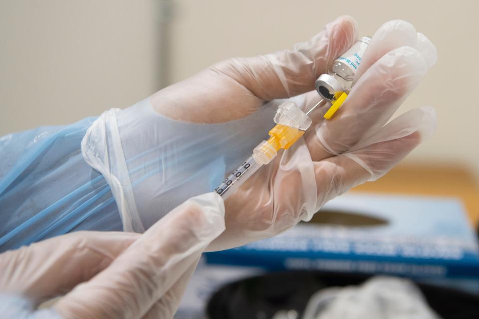 A nurse draws a syringe of the monkeypox vaccine.