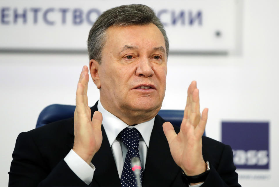 FILE - In this March 2, 2018 file photo, former Ukraine President Viktor Yanukovych gestures as he speaks at a news conference in Moscow. (AP Photo/Pavel Golovkin, File)