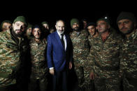 FILE In this file photo provided by the Armenian Prime Minister Press Service via PAN Photo, Armenian Prime Minister Nikol Pashinyan, center, poses for a photo with reservists of Armenian army before their leaving for Nagorno-Karabakh, in Yerevan, Armenia, Friday, Oct. 16, 2020. Armenians head to polls Sunday for an early parliamentary election stemming from a political crisis that has engulfed the country in the aftermath of the last year's fighting with Azerbaijan over the separatist region of Nagorno-Karabakh. Acting Prime Minister Nikol Pashinyan called the vote after months of mass protests demanding his resignation over his handling of the conflict. (Tigran Mehrabyan, Armenian Prime Minister Press Service/PAN Photo via AP, File)
