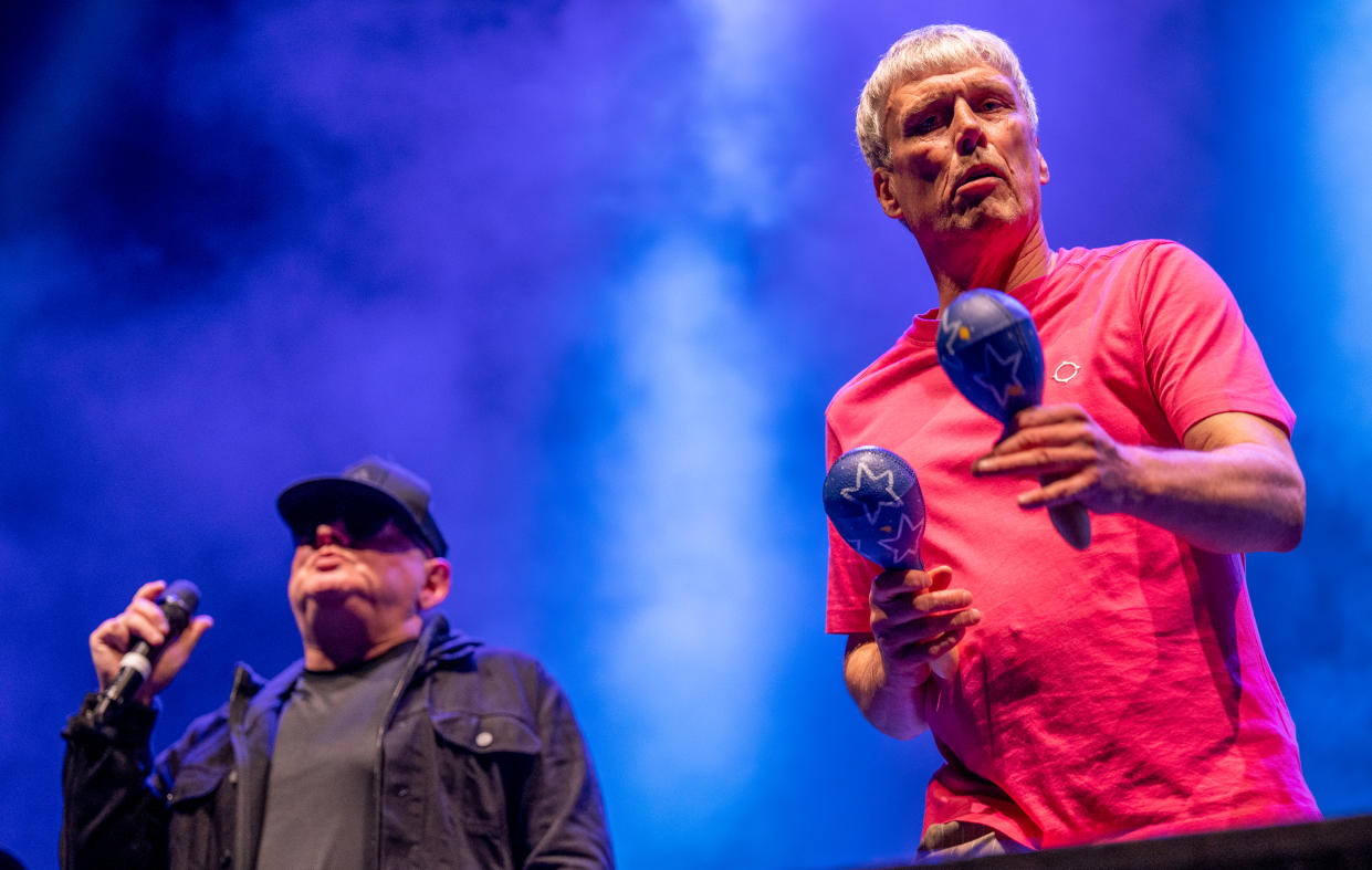 MANCHESTER, ENGLAND - DECEMBER 03: Bez and Shaun Ryder of Happy Mondays perform at Manchester Arena on December 03, 2021 in Manchester, England. (Photo by Shirlaine Forrest/WireImage)