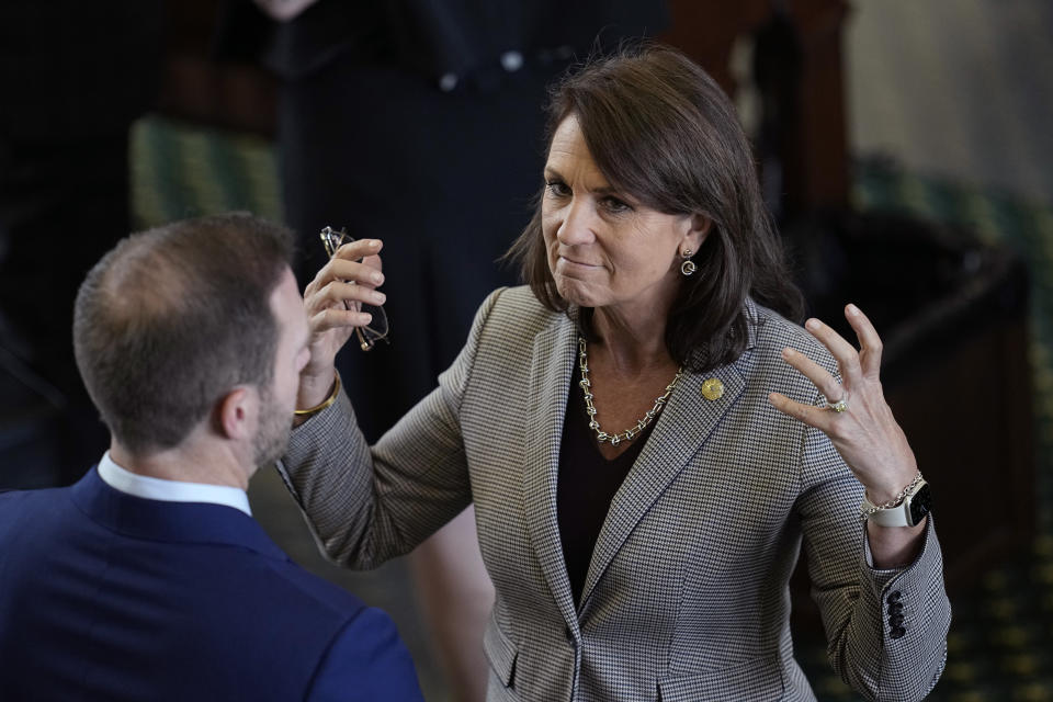 Texas state Sen. Angela Paxton, R-McKinney, wife of suspended Texas state Attorney General Ken Paxton, right, talks with a staff member during the impeachment trial her husband in the Senate Chamber at the Texas Capitol, Thursday, Sept. 14, 2023, in Austin, Texas. (AP Photo/Eric Gay)