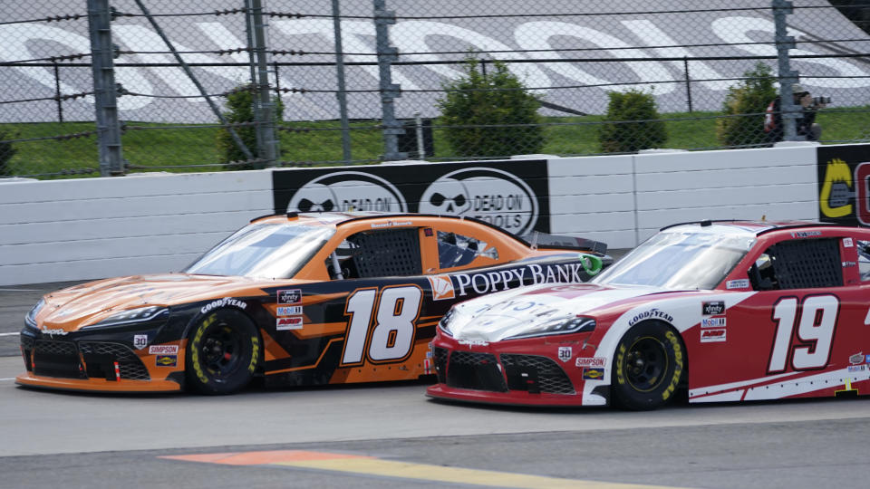 Daniel Hemric (18) and Brandon Jones (19) lead the field at the restart of the rain delayed NASCAR Xfinity Series auto race at Martinsville Speedway in Martinsville, Va., Sunday, April 11, 2021. (AP Photo/Steve Helber)