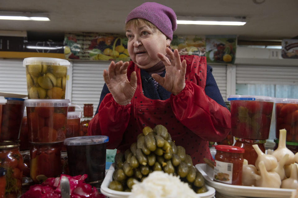 Tetyana Motorna appears at her stall in Volodymirsky market in Kyiv, Ukraine, on Feb. 9, 2023. Motorna, who has sold pickled fruit and vegetables for decades, supports chef Ievgen Klopotenko’s work to secure borsch as a national treasure for Ukraine. (AP Photo/Chris Warde-Jones)