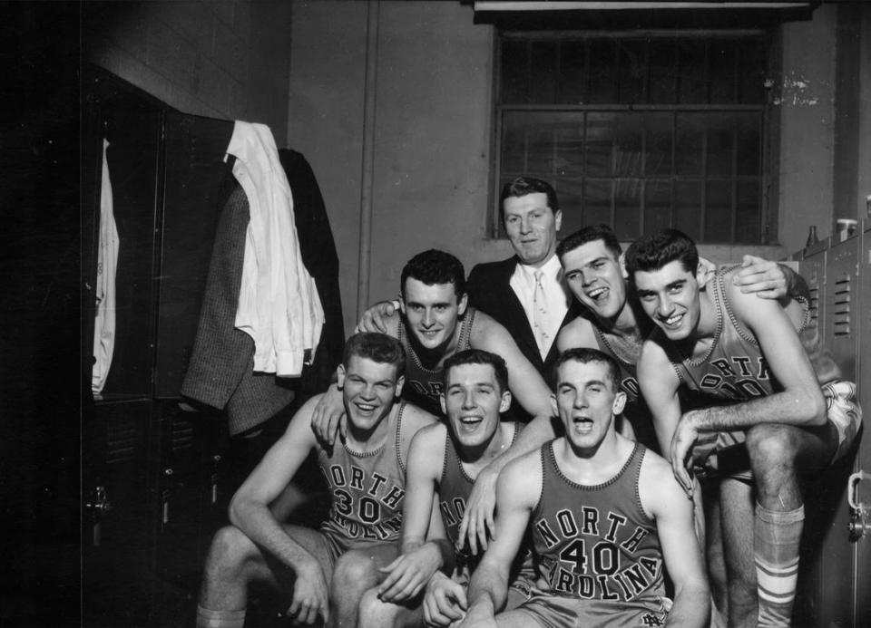 Coach Frank McGuire celebrates with members of the North Carolina team that went 32-0 in 1957.