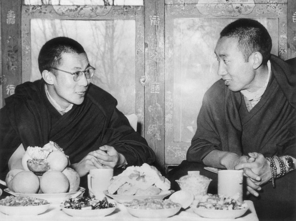 His Holiness the Dalai Lama of Tibet and the Panchen Lama (second in rank as spiritual leader), seated and talking at a dining table in Tibet.&nbsp;