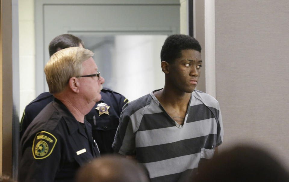 Sir Young, 20, is led into court before a hearing in Dallas Thursday, May 8, 2014. A district court judge has reversed a previous order and imposed a series of probationary requirements for the 20-year-old man convicted of raping a schoolmate. The initial punishment for Young sparked a backlash when a prior judge in Dallas sentenced him to five years of probation and declined to impose standard conditions of probation for sex offenders. (AP Photo/LM Otero)